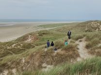 A group of hikers in the dunes